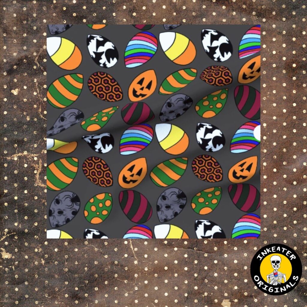 Dark gray fabric with candy corn shaped Easter eggs featuring horror icons including jack-o-lanterns, skulls, spiders and Freddy Krueger stripes